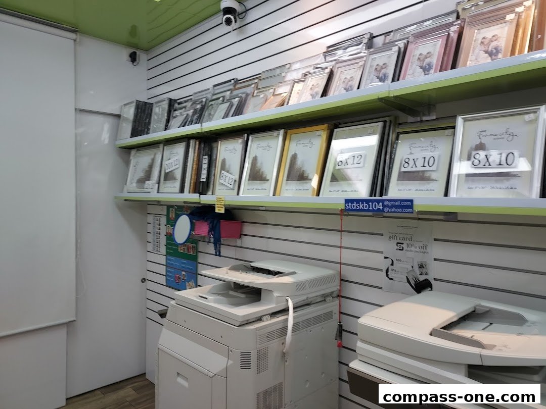 A shop interior displaying various photo frames and printing equipment.