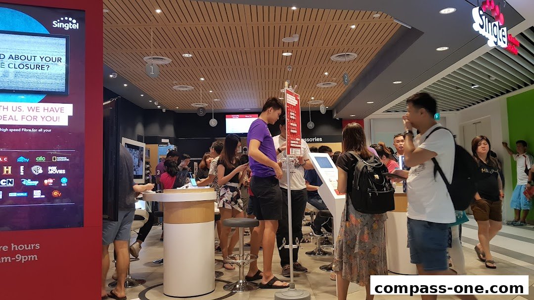 Customers are browsing at a busy Singtel Exclusive Retailer store.