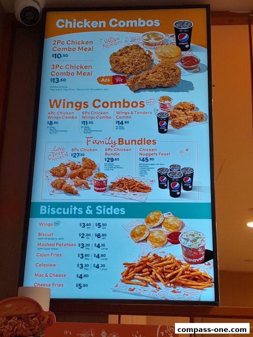 A menu board for Popeyes featuring chicken combos, wings, family bundles, and sides.