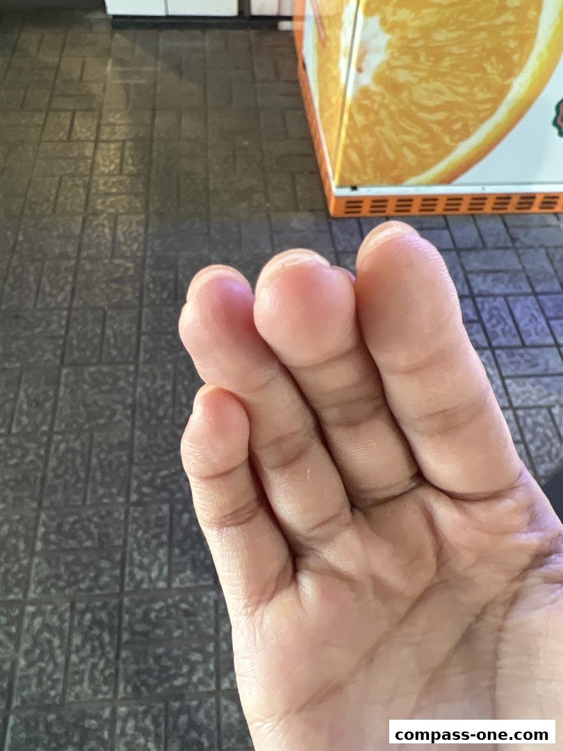 A close-up of a hand with fingers extended, showing the palm and fingers.