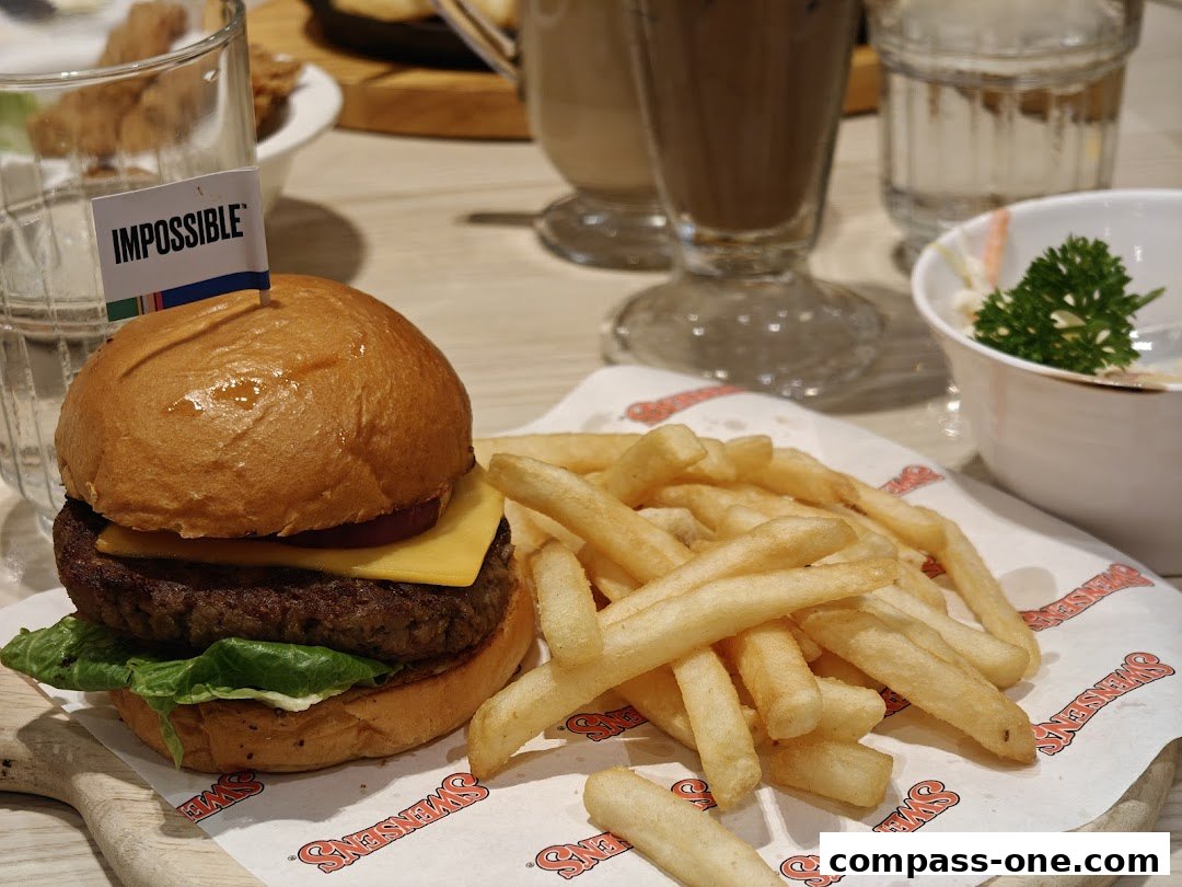 A delicious Impossible burger with fries and a side salad at Swensen's.