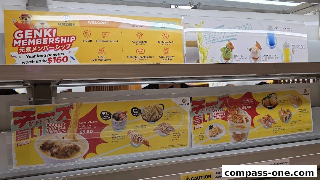 A display of Japanese food items and desserts offered at Genki Sushi.