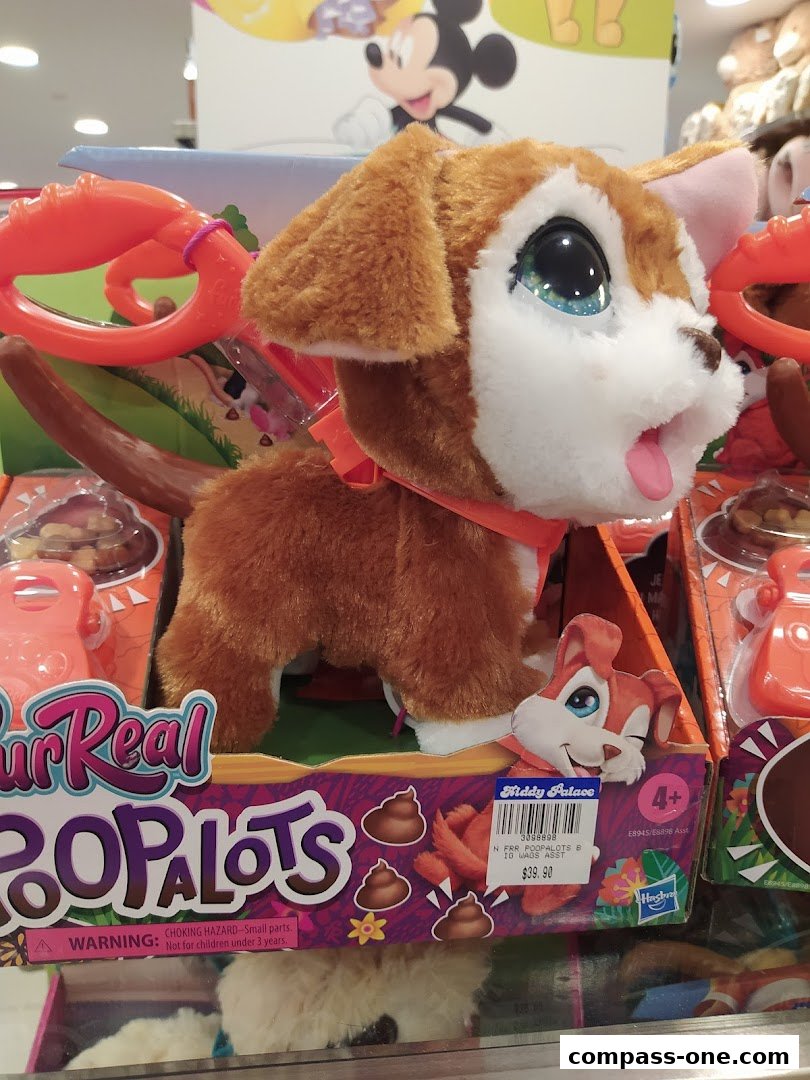 A FurReal Poopalots interactive toy dog is displayed in its packaging.