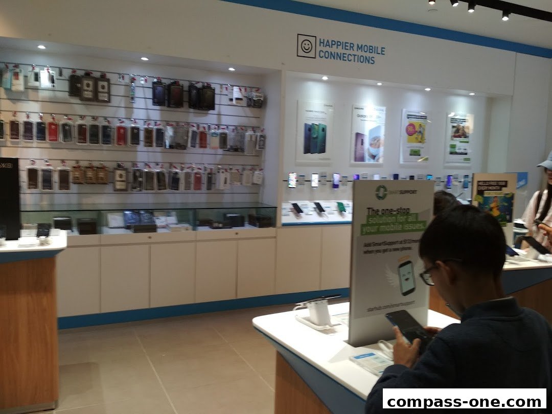 Interior of a mobile phone store with displays of phones and accessories.