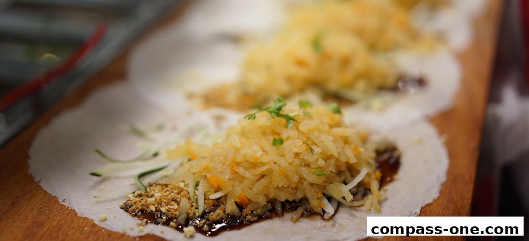 Close-up of delicious popiah skins filled with savory ingredients and topped with peanuts.