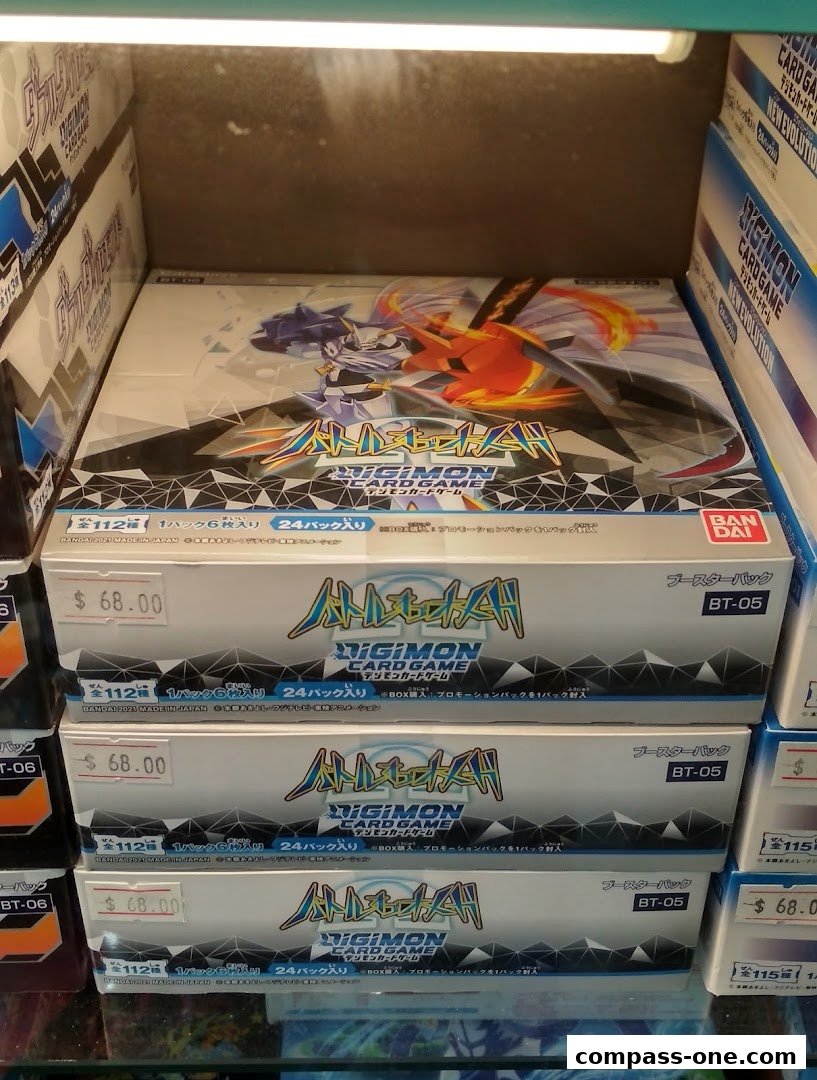Boxes of Digimon Card Game booster packs are stacked and displayed for sale.
