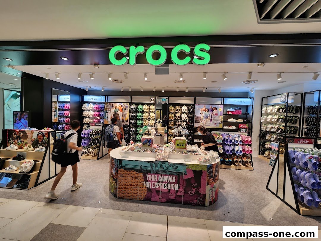 Interior view of a Crocs store showcasing a wide variety of colorful footwear and accessories.