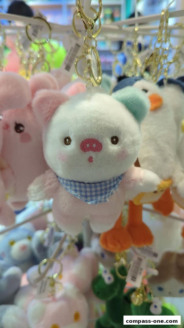 Close-up of cute plush animal keychains, featuring a pig and other characters.