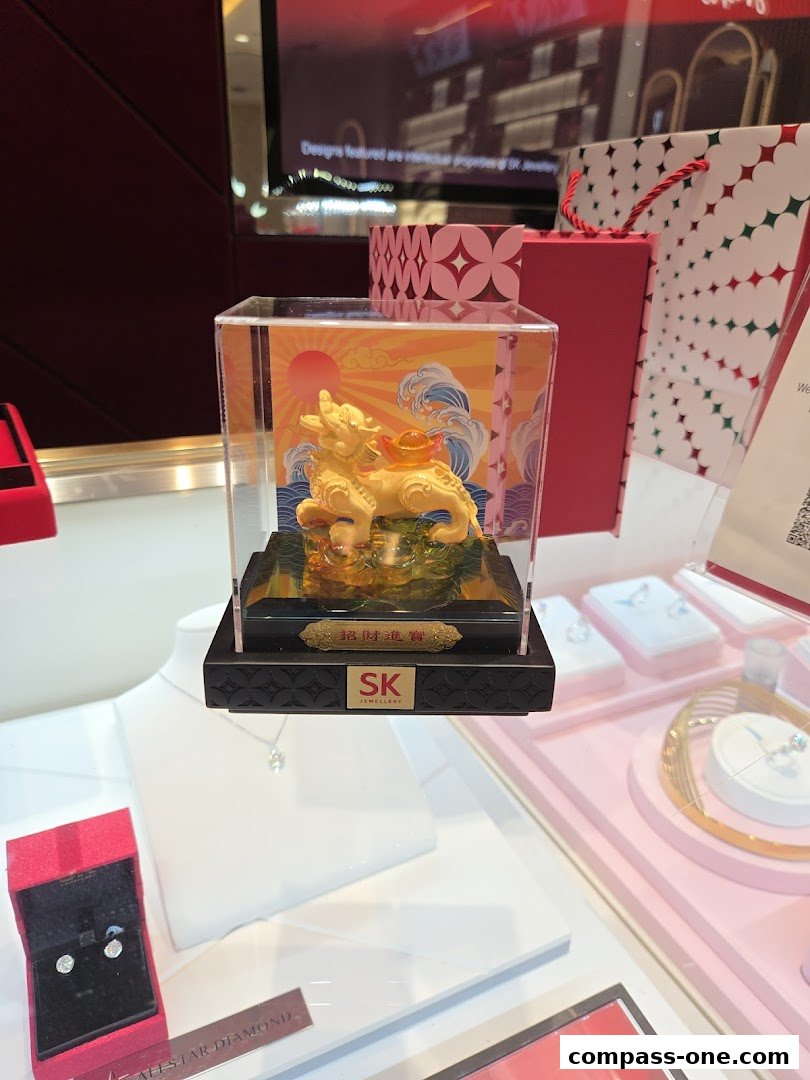A display case showcases a golden statue and jewelry from SK Jewellery.