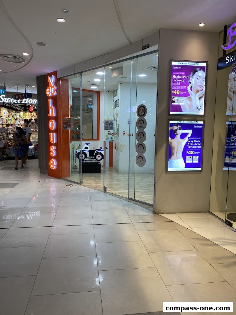 The entrance to EC House, a beauty salon, with promotional posters displayed.