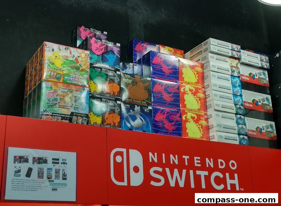 A display of various Pokemon Elite Trainer Boxes and Nintendo Switch accessories.