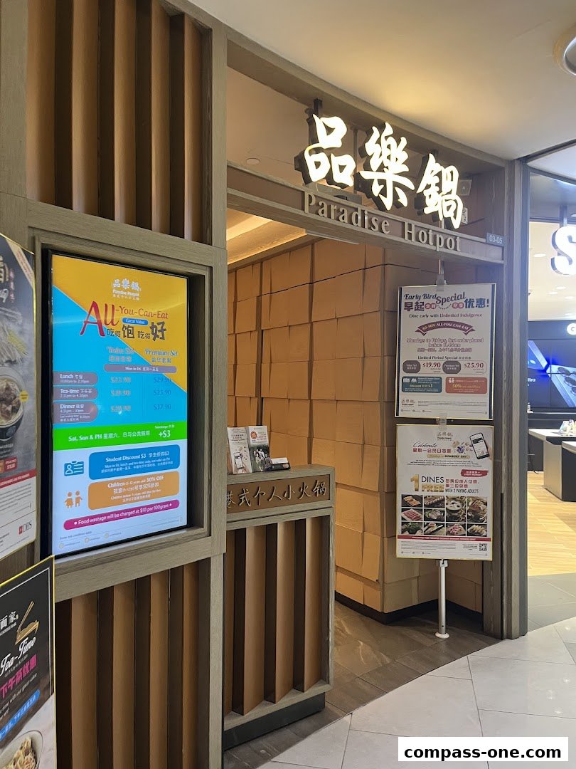 The entrance of Paradise Hotpot restaurant with promotional posters displayed.