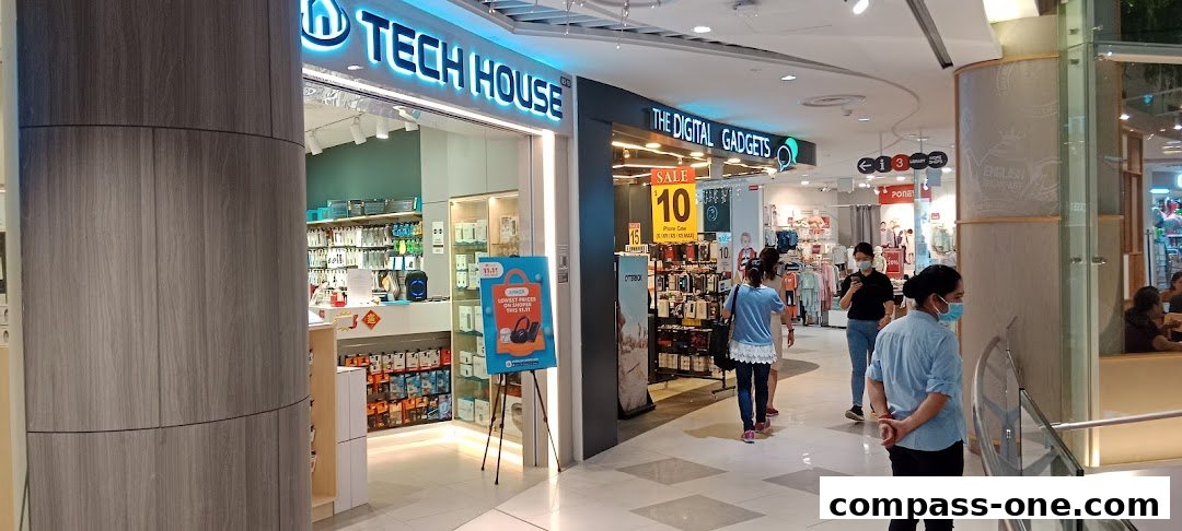 The Tech House shop entrance with various electronic accessories and a sale promotion sign.