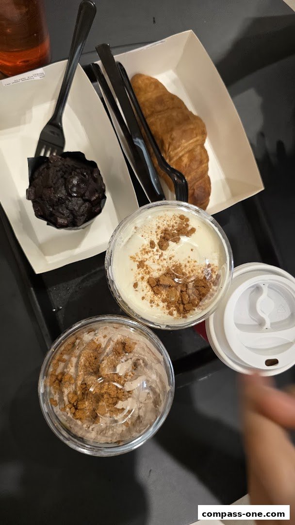 A tray with coffee drinks, a chocolate muffin, and a croissant.