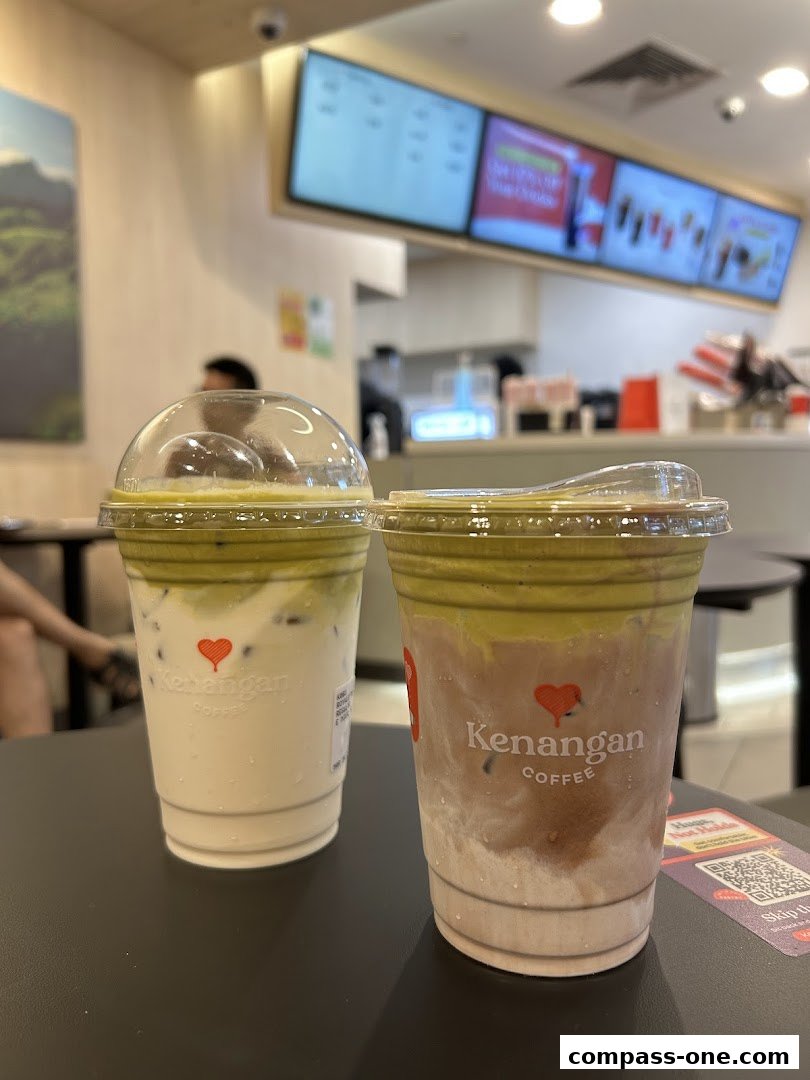 Two iced coffee drinks from Kenangan Coffee are displayed on a table.