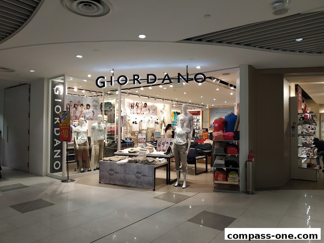 The Giordano store features mannequins displaying casual wear and shelves stocked with folded clothing.