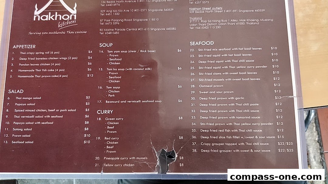A menu for Nakhon Kitchen, featuring Thai appetizers, salads, soups, curries, and seafood dishes with prices.