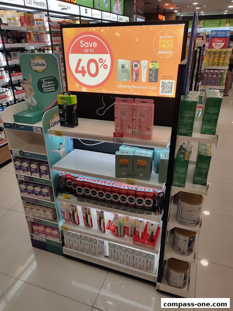A display of personal care products including toothpaste, razors, and supplements with a promotional sign.