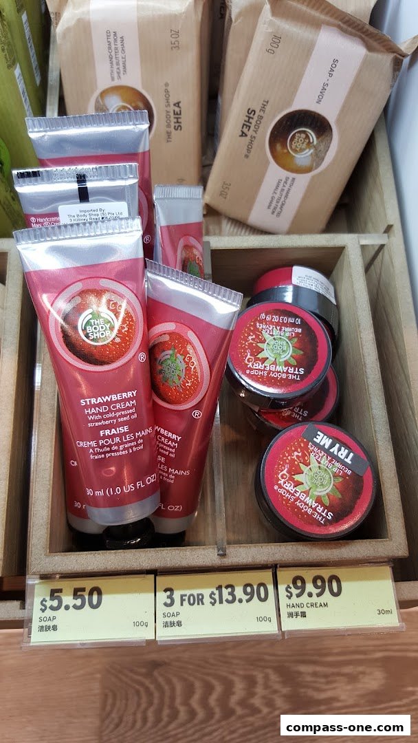 A display of The Body Shop's strawberry hand creams and shea soaps with price tags.