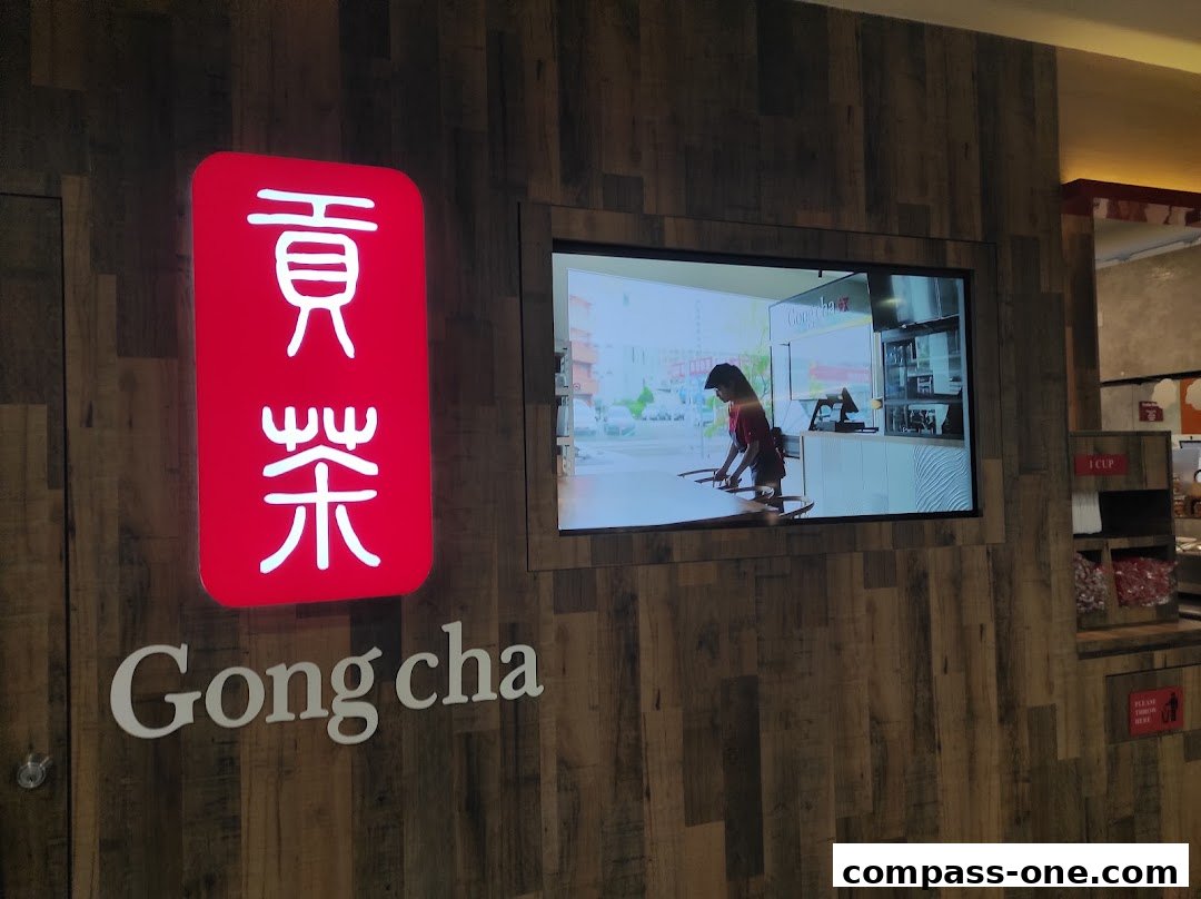 The Gong Cha logo and a screen showing a barista preparing drinks.