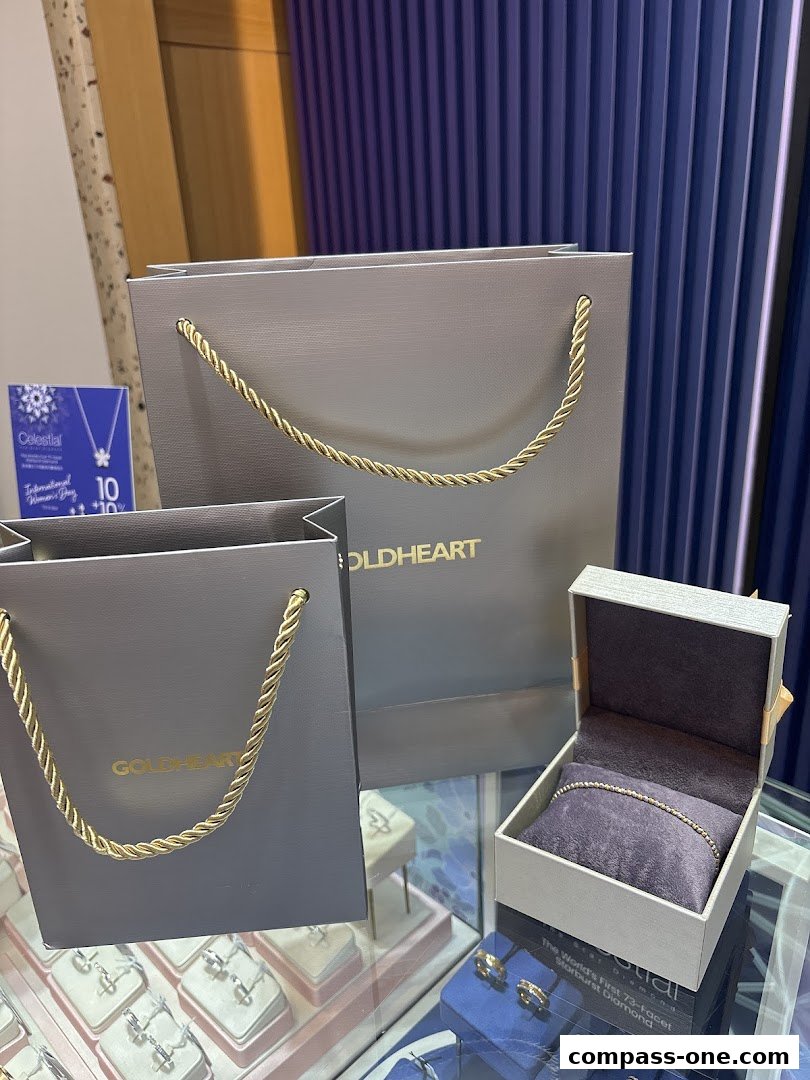 Goldheart jewelry shop display featuring shopping bags and an open jewelry box with a bracelet.