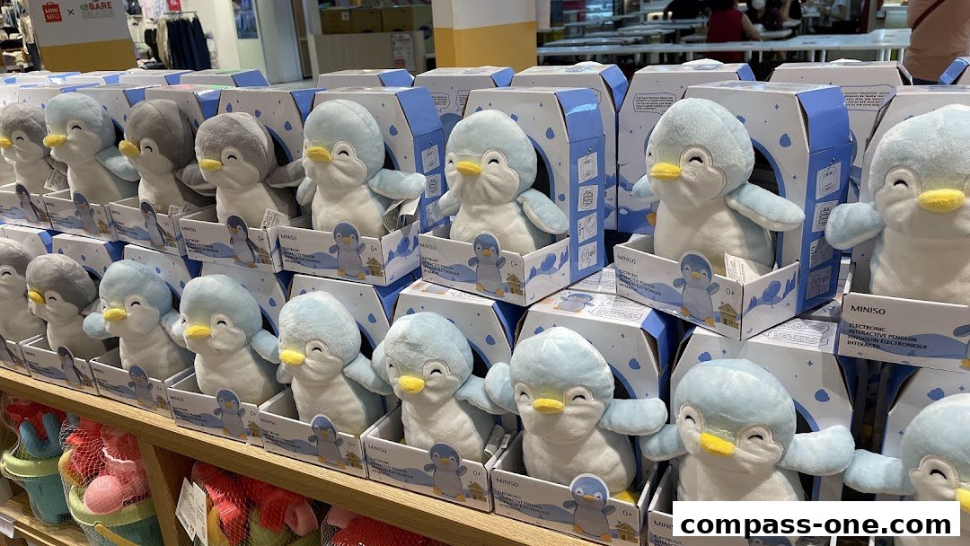 Rows of cute penguin plush toys in their packaging on display shelves.