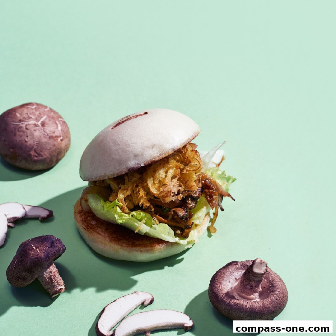 A delicious mushroom bao bun with fresh lettuce and crispy toppings, surrounded by mushrooms.