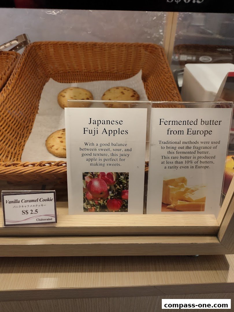 A display of cookies and baked goods with descriptive labels at Châteraisé.