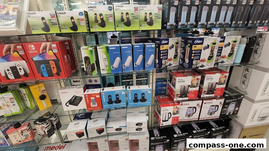 Shelves stocked with electronics including phones, gaming consoles, kettles, and blenders.