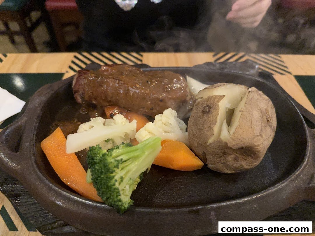A sizzling steak served with a baked potato and steamed vegetables on a cast iron plate.