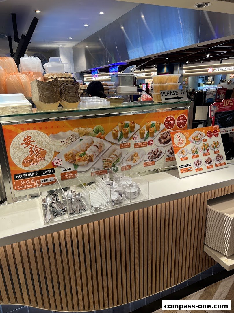 A food stall counter displaying a menu with various popiah dishes and prices.