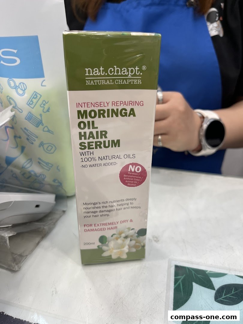 A box of Nat. Chapt. Moringa Oil Hair Serum is displayed, highlighting its benefits for dry and damaged hair.