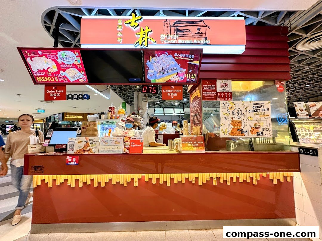 A Shihlin Taiwan Street Snacks stall with a menu display and staff serving customers.