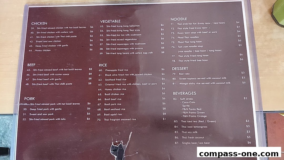 A menu from Nakhon Kitchen featuring Thai dishes like chicken, beef, pork, noodles, rice, desserts, and beverages.