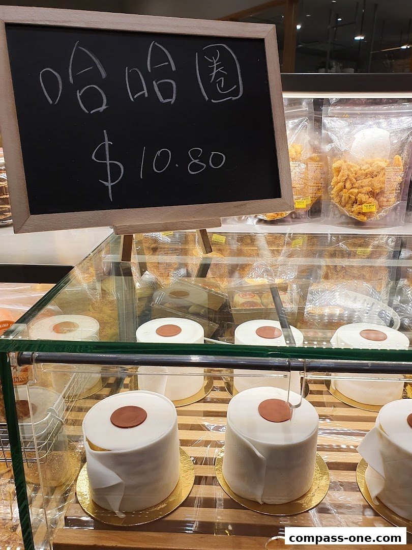 A display of white cakes with brown centers, with a blackboard sign indicating a price.