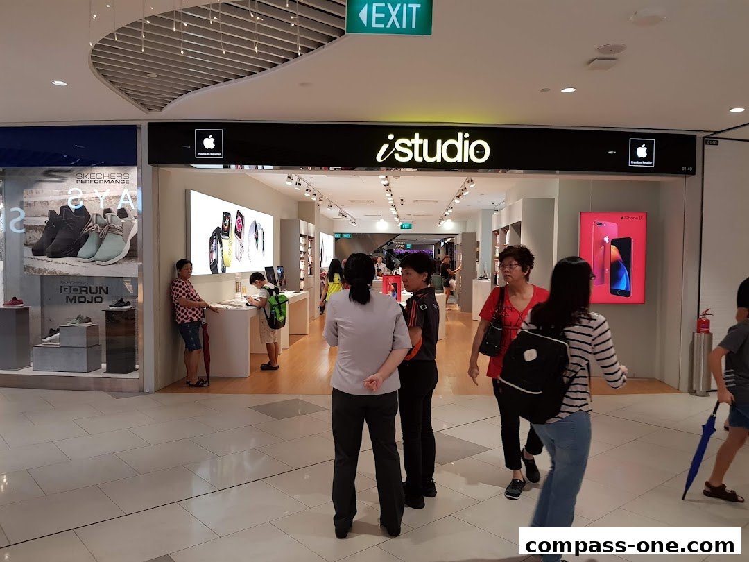 The entrance of an iStudio Apple Premium Reseller store with customers browsing.