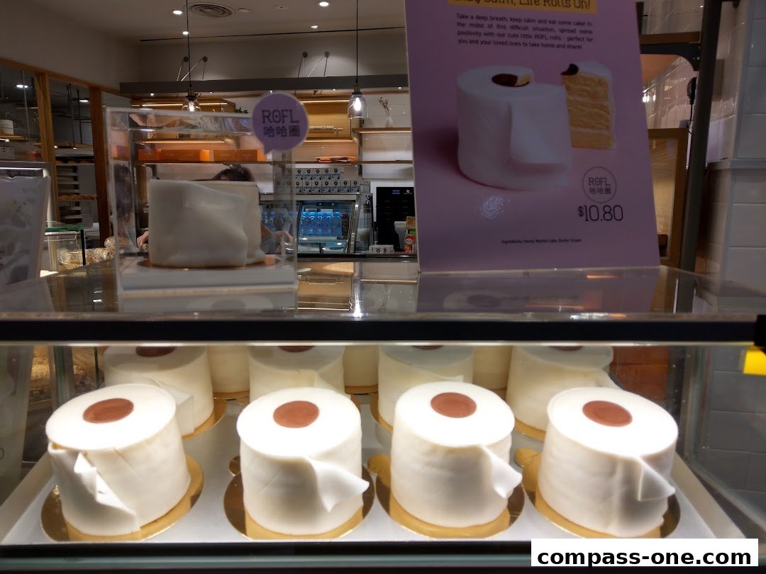 A display case filled with cakes shaped like rolls of toilet paper at BreadTalk.