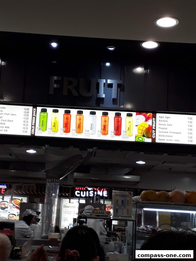 A menu board displaying various fruit juices and cut fruits with prices.