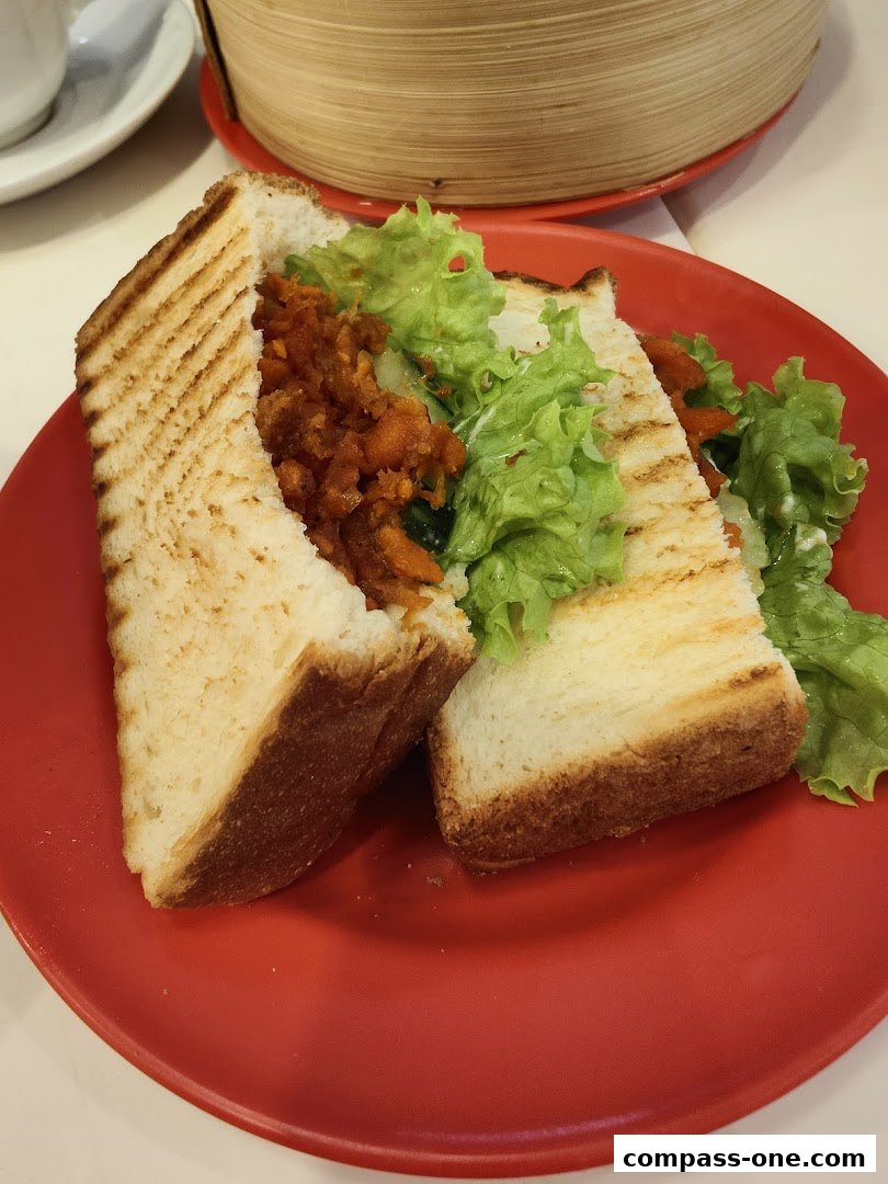 A close-up shot of a delicious sandwich with toasted bread, lettuce, and filling on a red plate.