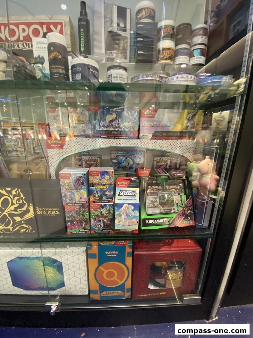 A display case filled with various trading card game products and collectible items.