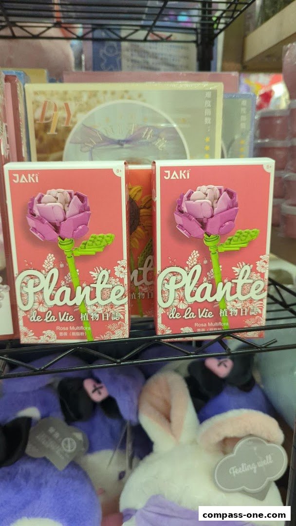 Two boxes of JAKI Plante de la Vie building blocks featuring pink roses are displayed on a shelf.