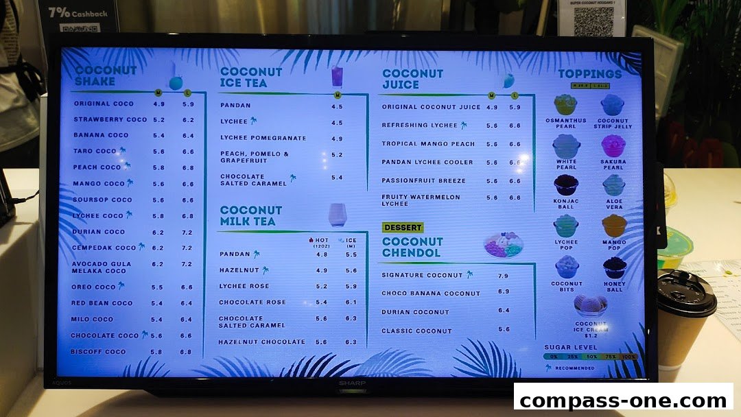 A digital menu displaying various coconut shakes, ice teas, juices, desserts, and toppings.
