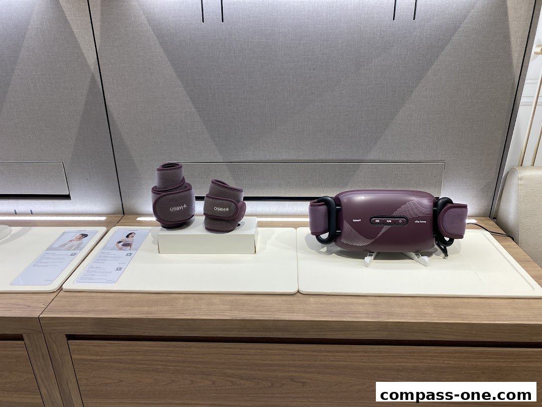 OSIM massage devices displayed on a wooden counter with informational cards.
