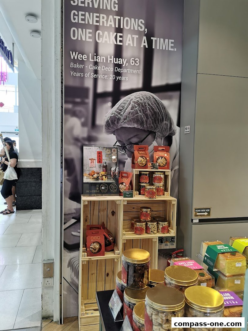 A display of cakes and cookies from Polar Puffs & Cakes with a large promotional banner.