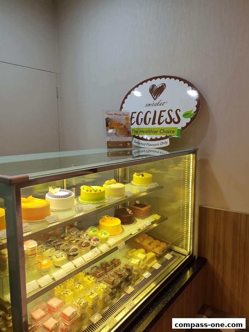 A display case filled with various cakes and pastries at Emicakes.