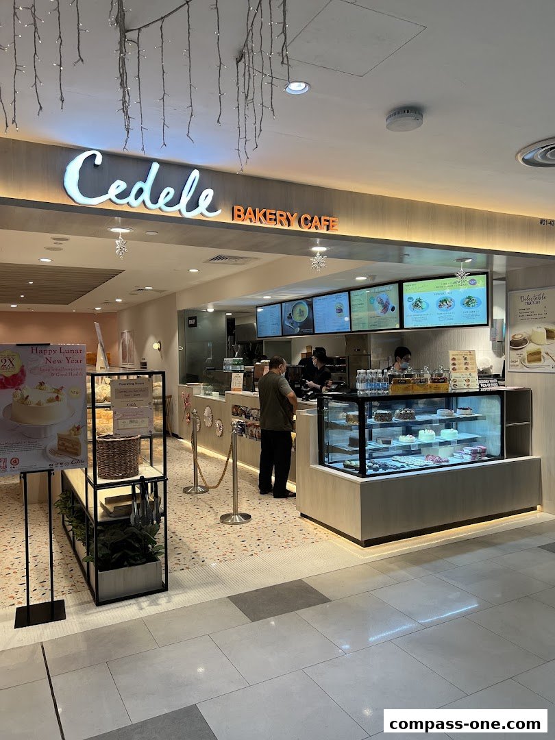 The Cedele Bakery Cafe storefront with a display of cakes and a menu board.