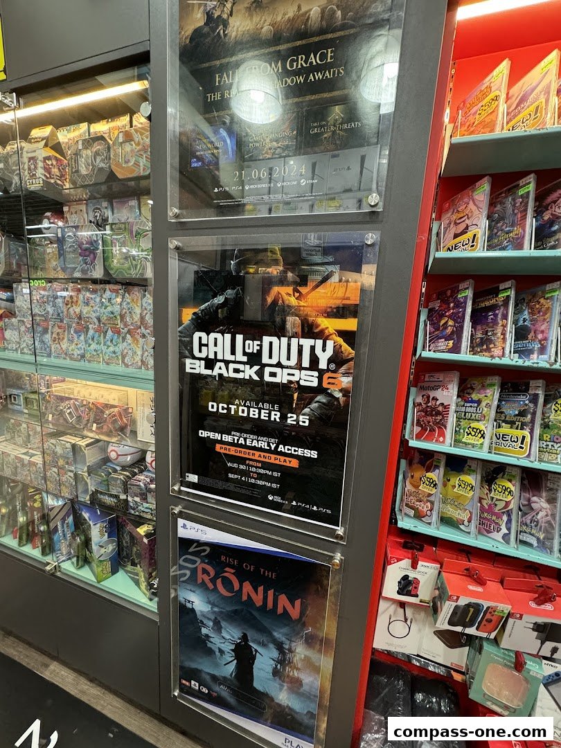A display of video games and gaming accessories, featuring posters for Call of Duty and Rise of the Ronin.