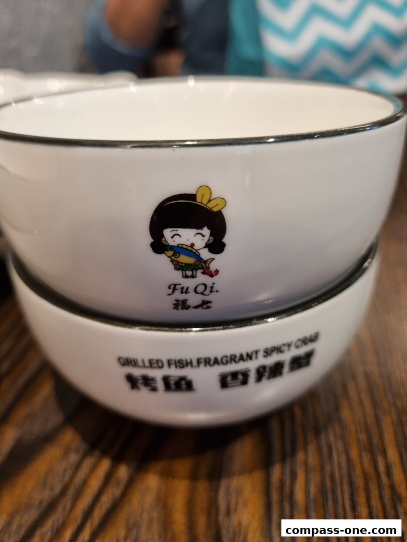 Two white ceramic bowls with a cartoon girl and Chinese characters.