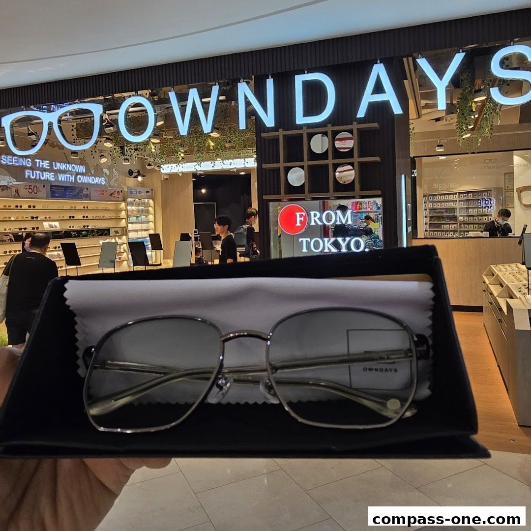 A pair of glasses is presented in front of the OWNDAYS optical shop.