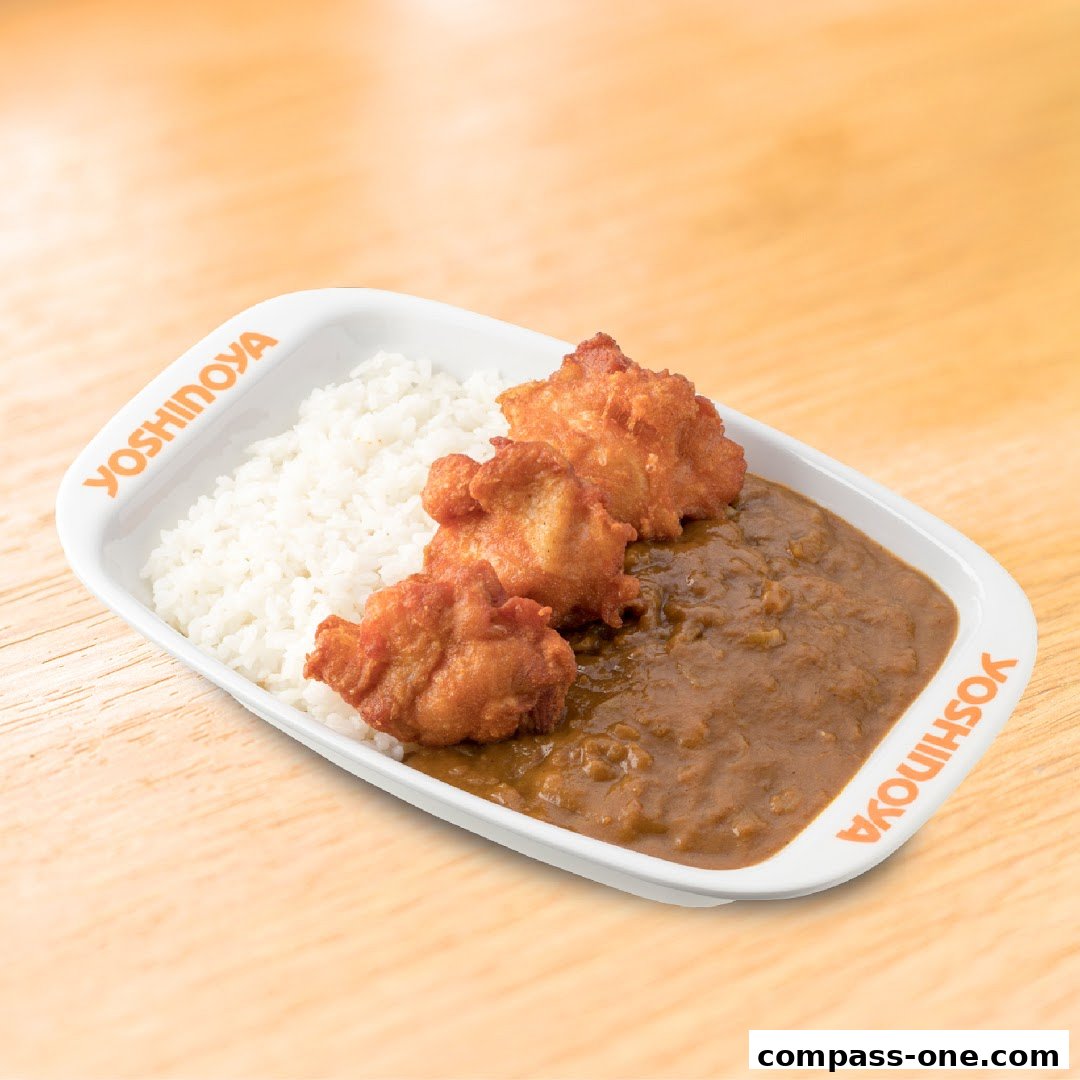 A plate of Yoshinoya's signature curry with rice and crispy fried chicken pieces.